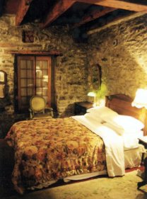 Stone bedroom with country rose bedspread