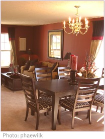 open-plan brown-walled dining room with pale carpet