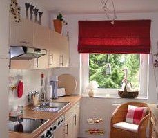 white kitchen with red blind