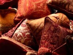 collection of cushions in shades of red and orange